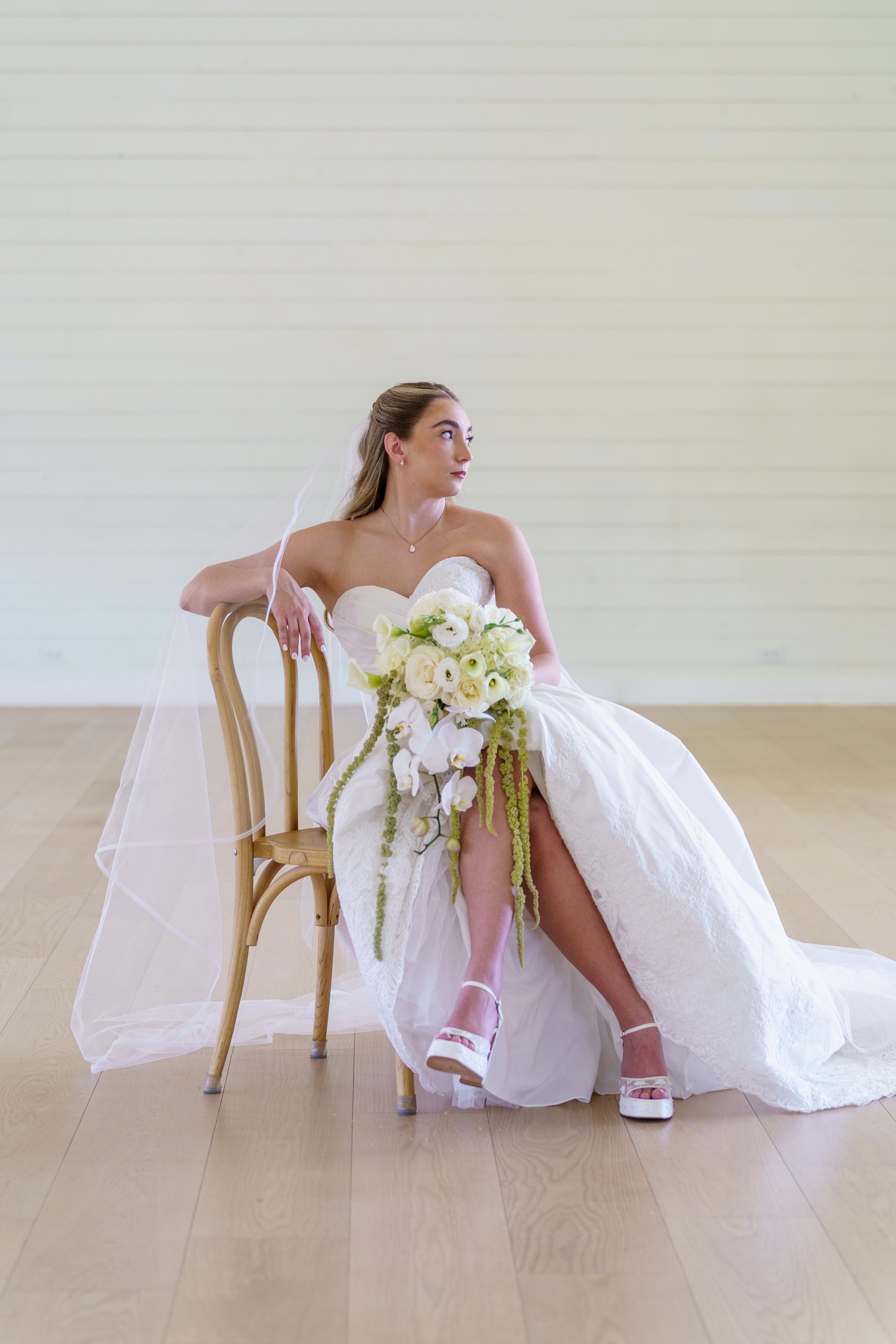 Melanie sitting and looking away in her wedding dress
